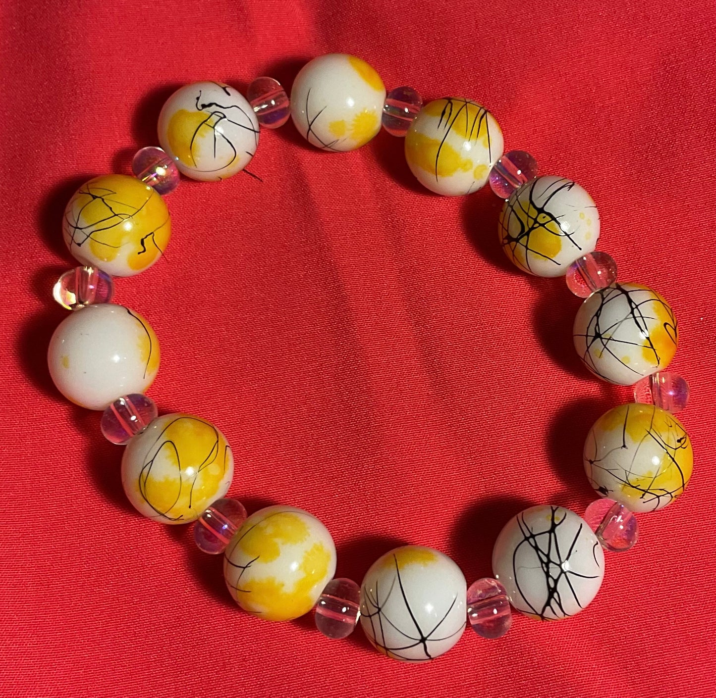 Yellow and White glass beaded bracelet on 7 inch elastic thread. Adjustable.