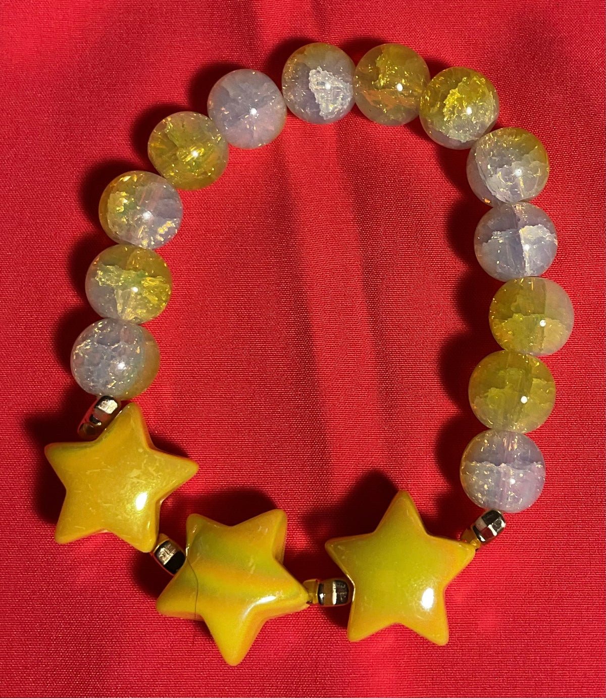 Yellow Stars with yellow and white accents bracelet on 7 inch elastic thread. Adjustable.