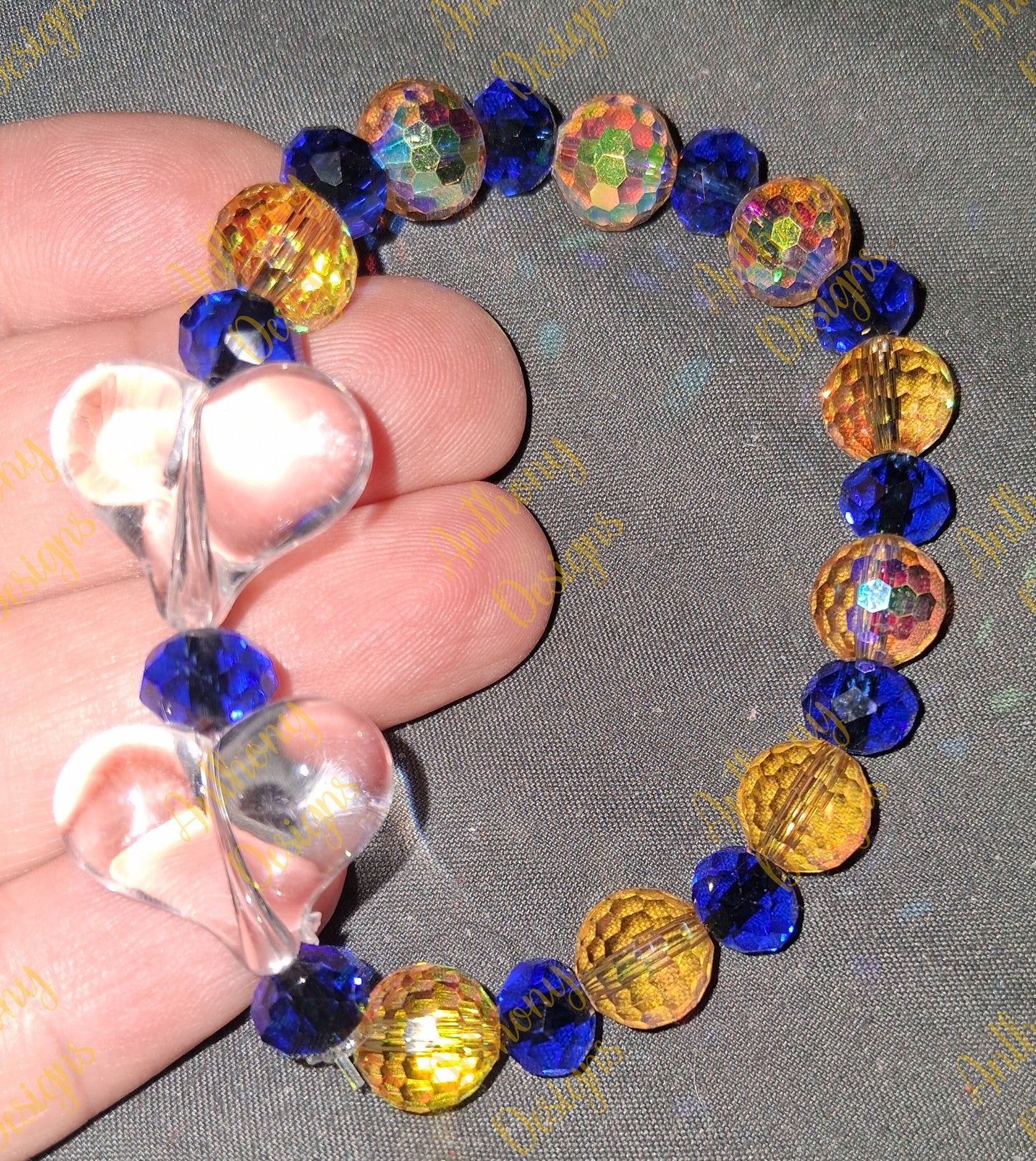 Clear Hearts royal blue and gold bracelet on 7 inch elastic thread. Adjustable.