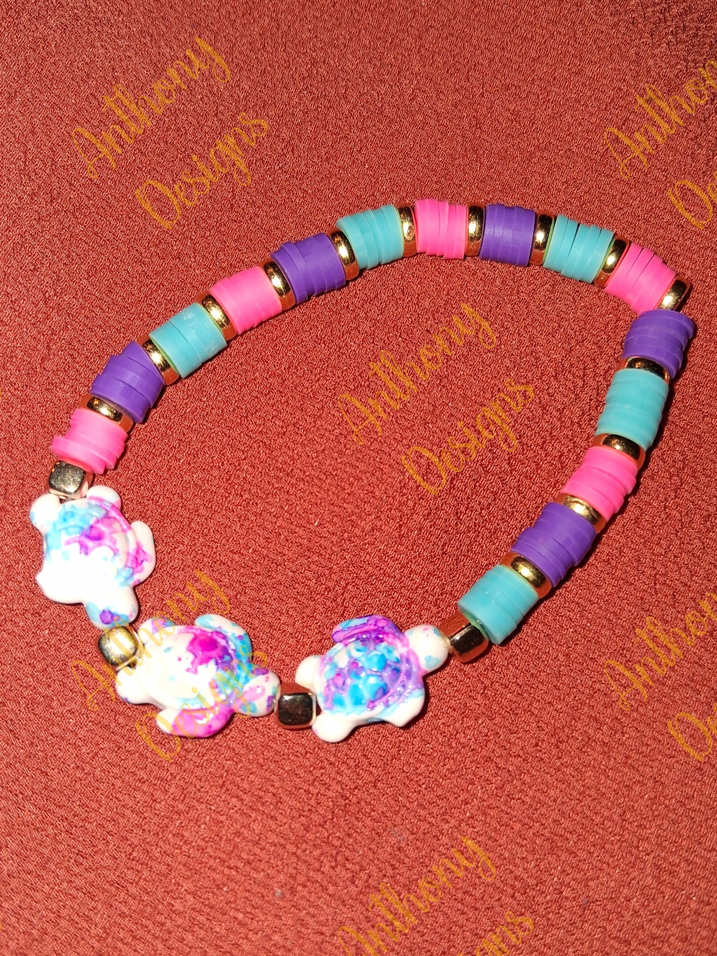 Turtle beads with pink blue and purple accents bracelet on 7 inch elastic thread. Adjustable.