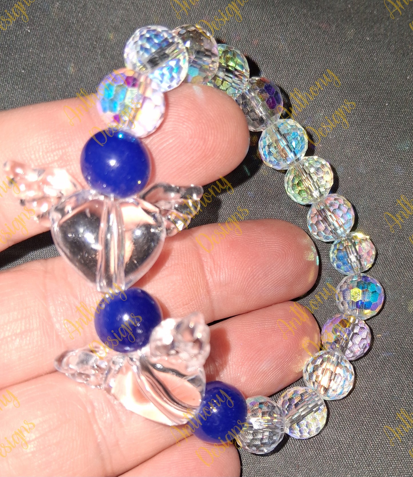Clear Hearts with wings royal blue bracelet on 7 inch elastic thread. Adjustable.