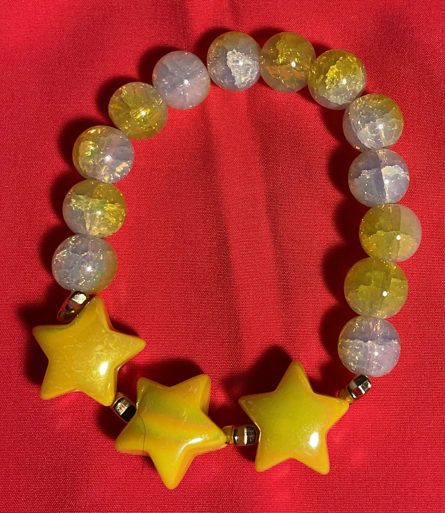 Yellow Stars with yellow and white accents bracelet on 7 inch elastic thread. Adjustable.