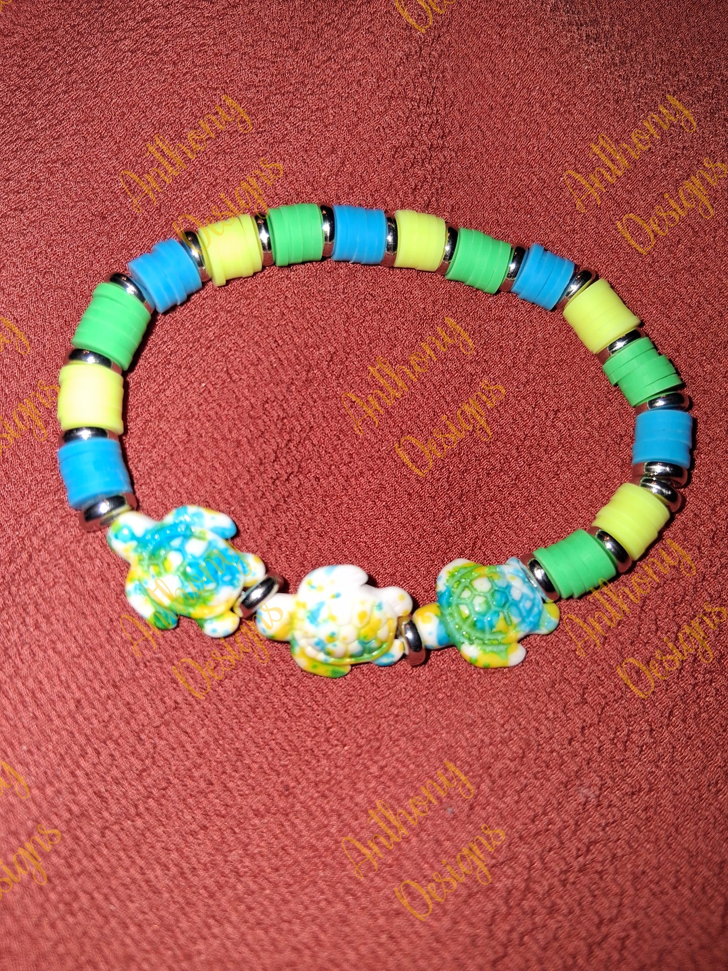Turtle beads with yellow blue and green accents bracelet on 7 inch elastic thread. Adjustable.